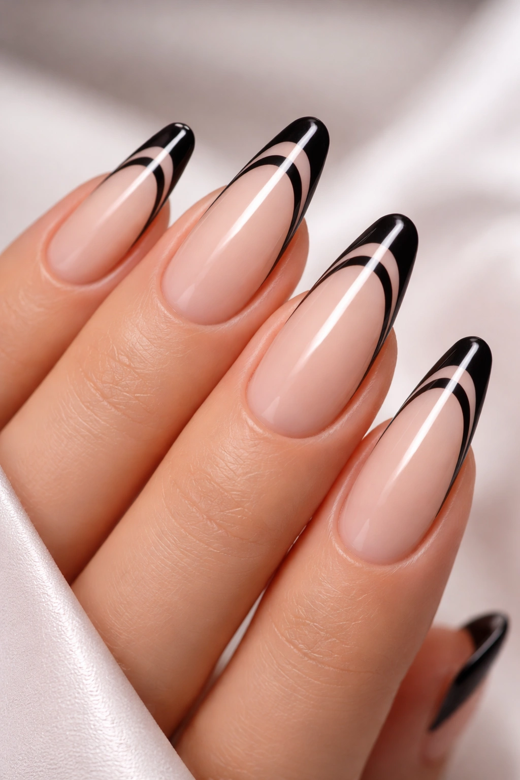 Close-up of nails with two black French tips stacked on longer nails