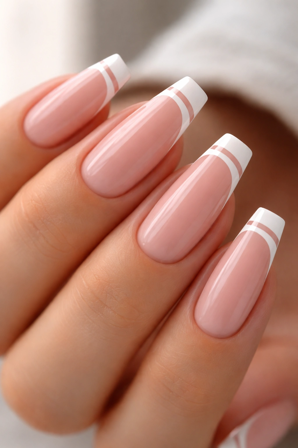 Close-up of ballerina nails with two thin white lines and a clear space