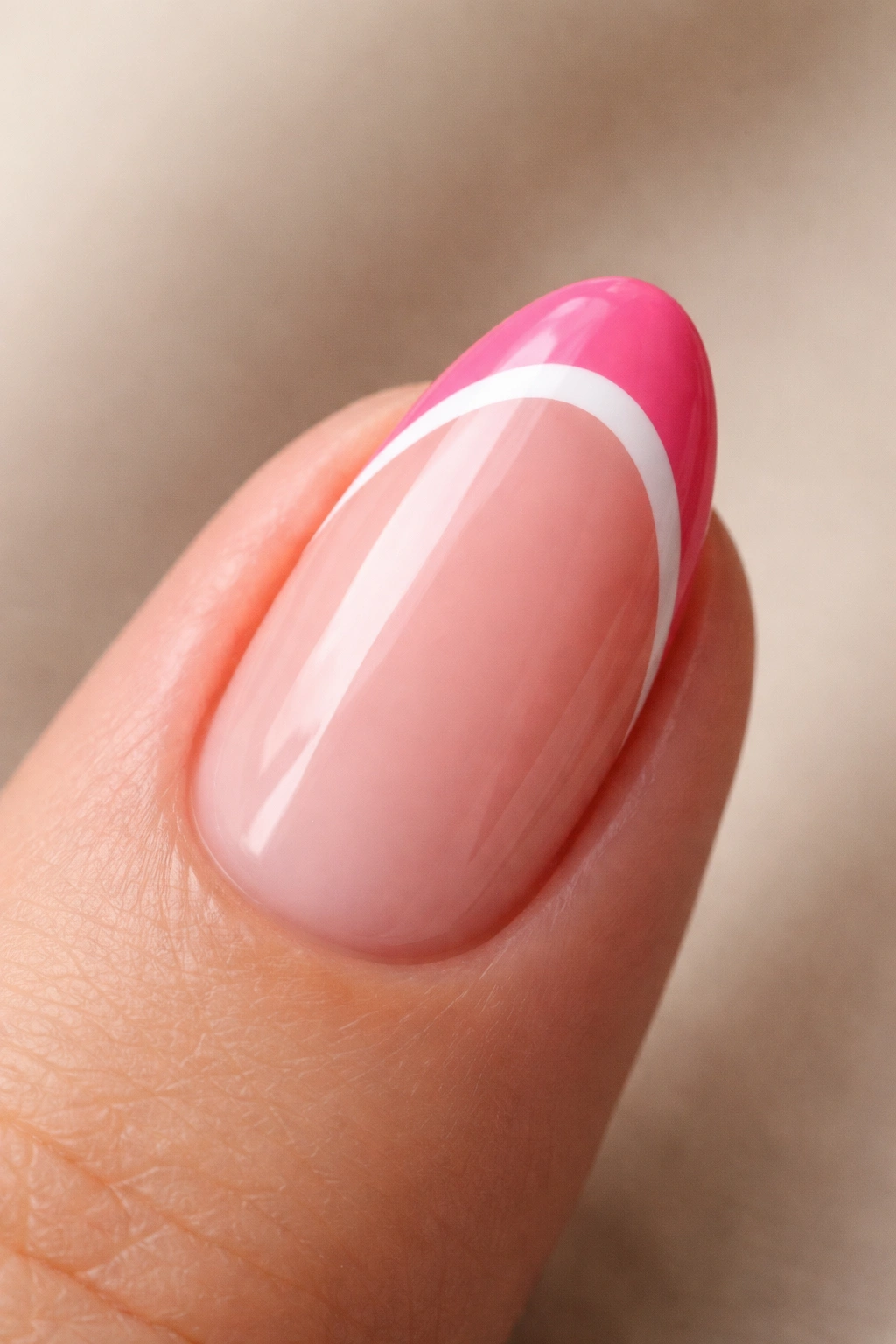 Close-up of a short almond nail with double French tip in pink and white