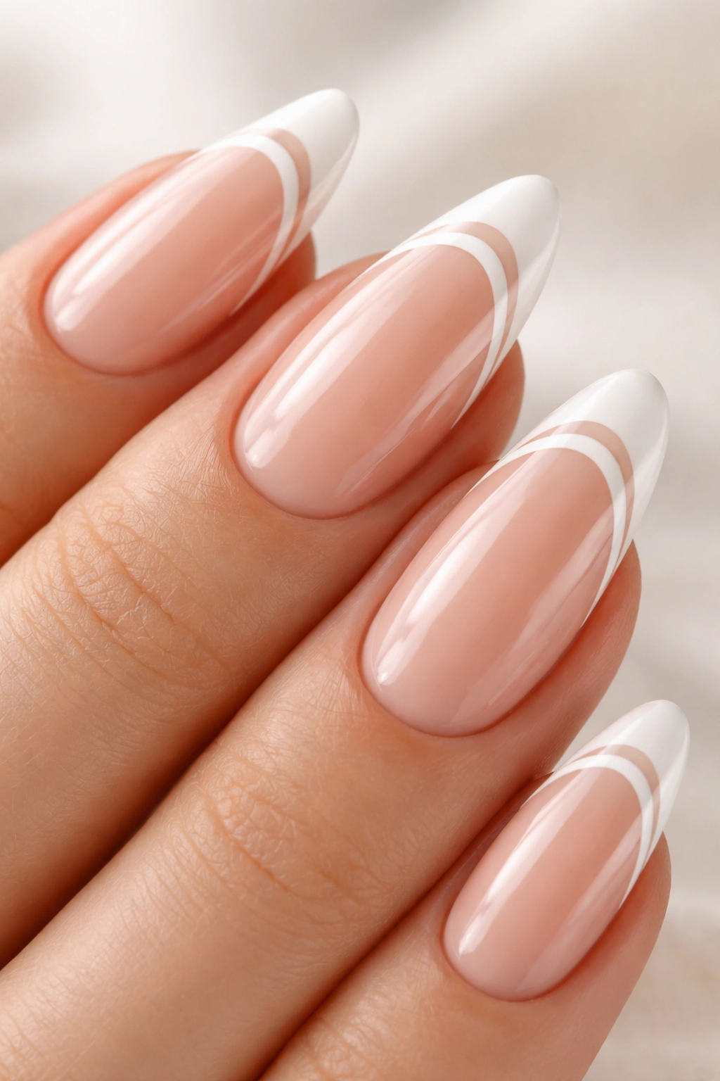 Close-up almond nail with two slim white lines and negative space at the tip