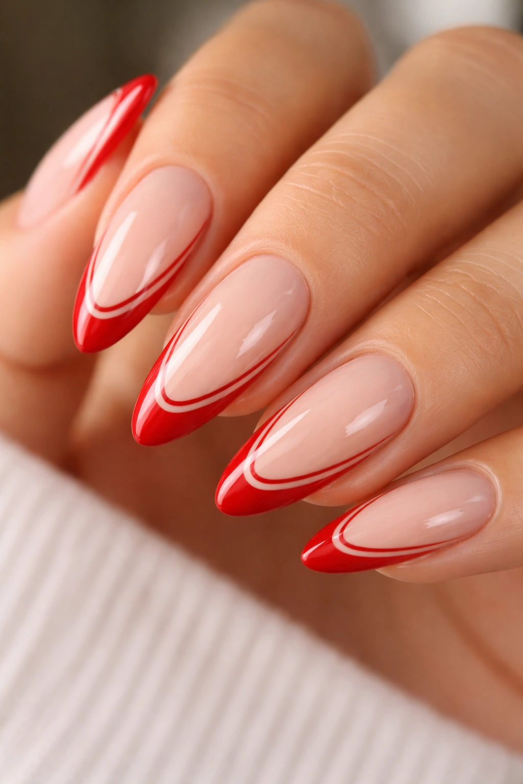 Almond nails with double red French tips and an inner line