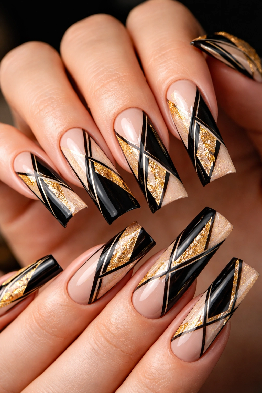 Long duck nails with black geometric patterns and gold accents.