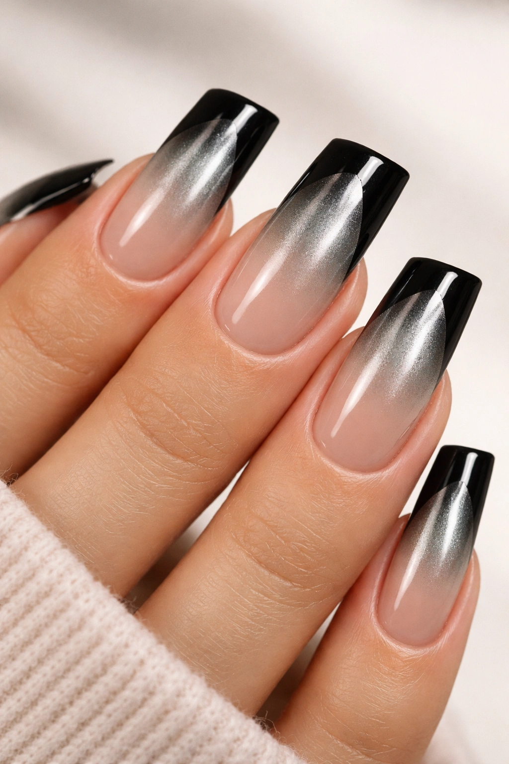 Close-up of duck nails with chrome ombre gradient and black tip line