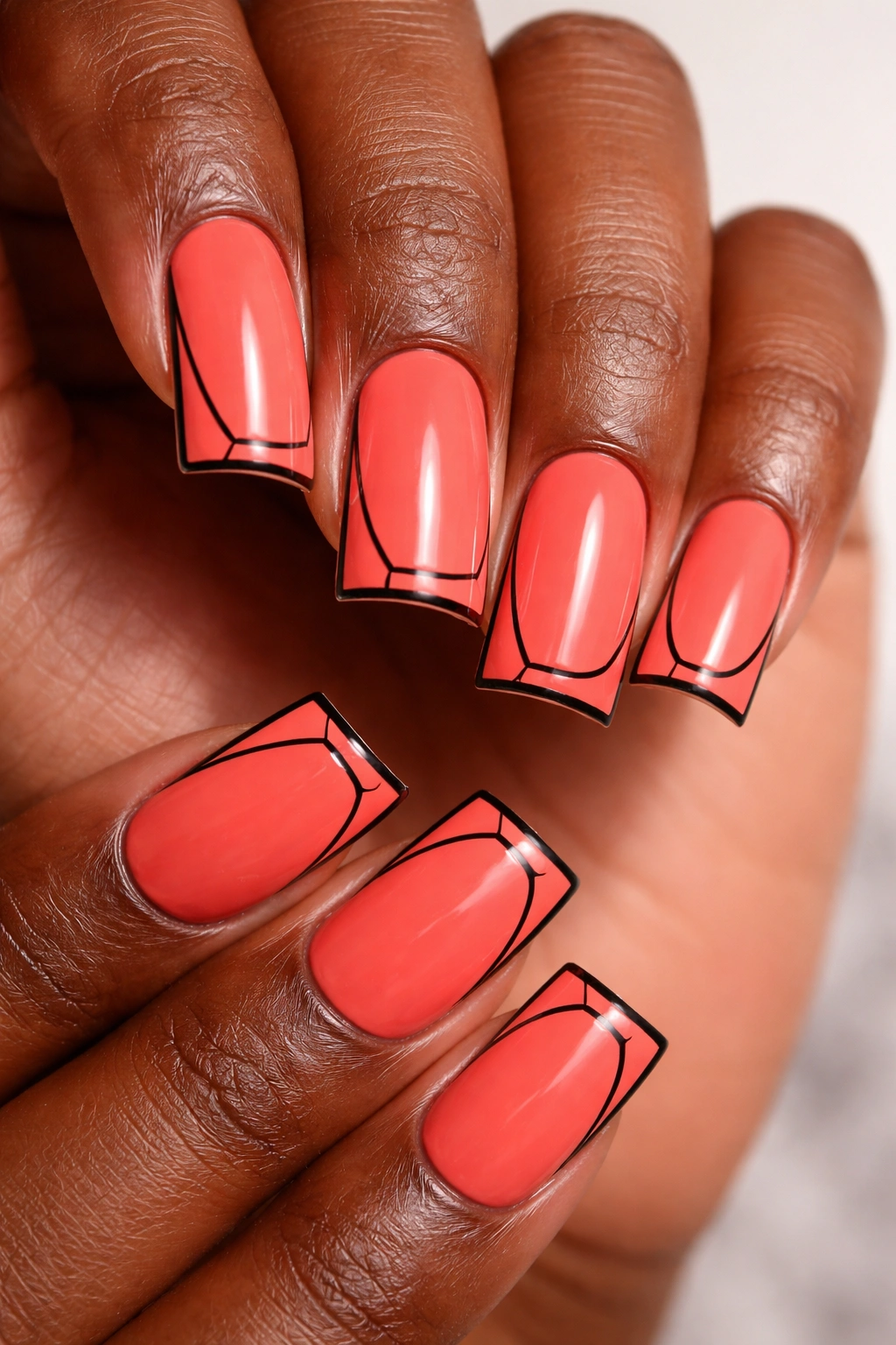 Coral duck nails with black geometric outlines