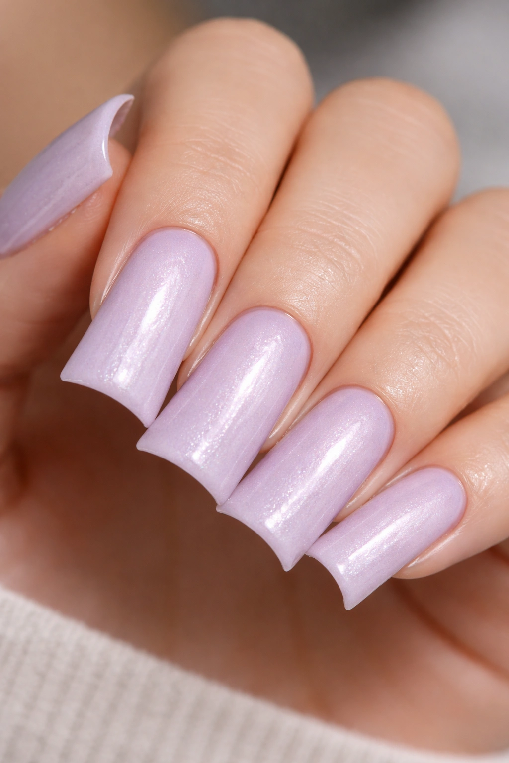 Close-up of duck nails in pale lavender with soft shimmer