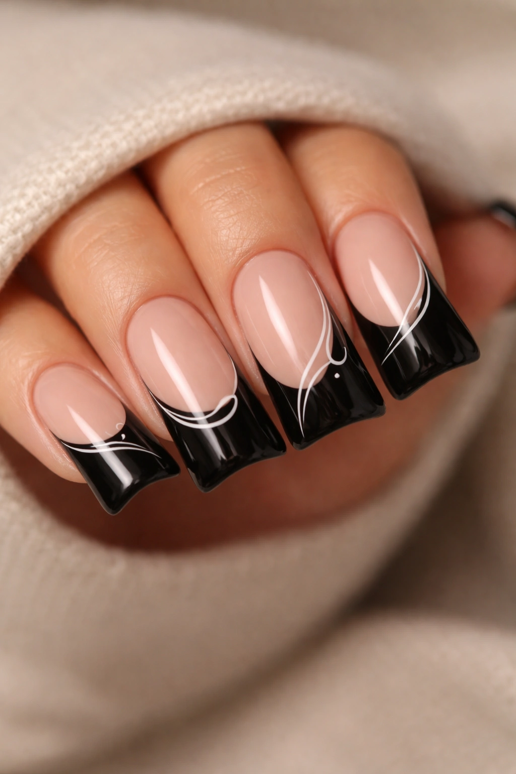 Close-up of duck nails with minimalist line art on black tips