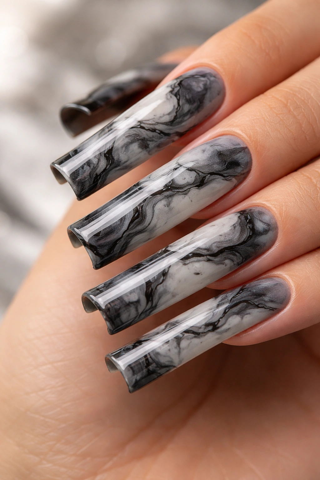 Duck nails with grey-black-white marble pattern.
