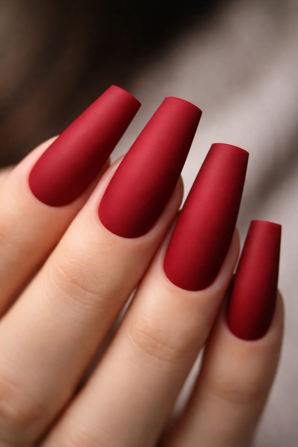 Close-up of duck nails in sophisticated matte red finish