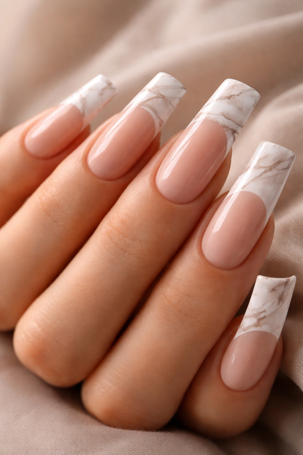 Close-up of duck nails with nude marble veining on the white tip