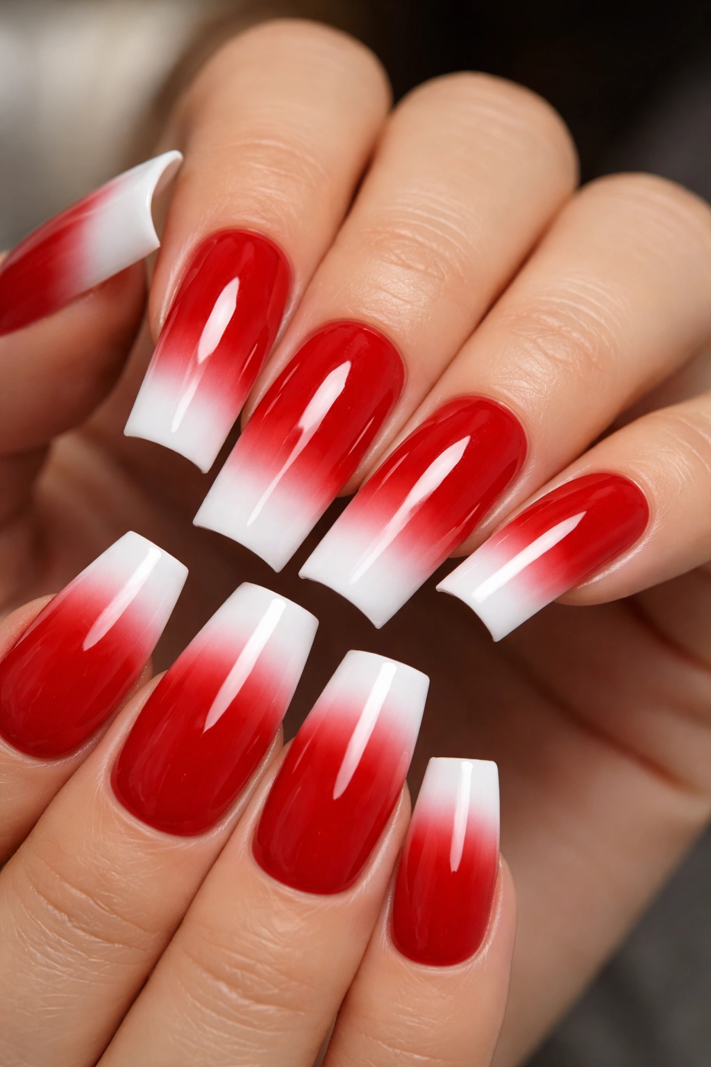 Close-up of duck nails with red base and white tips