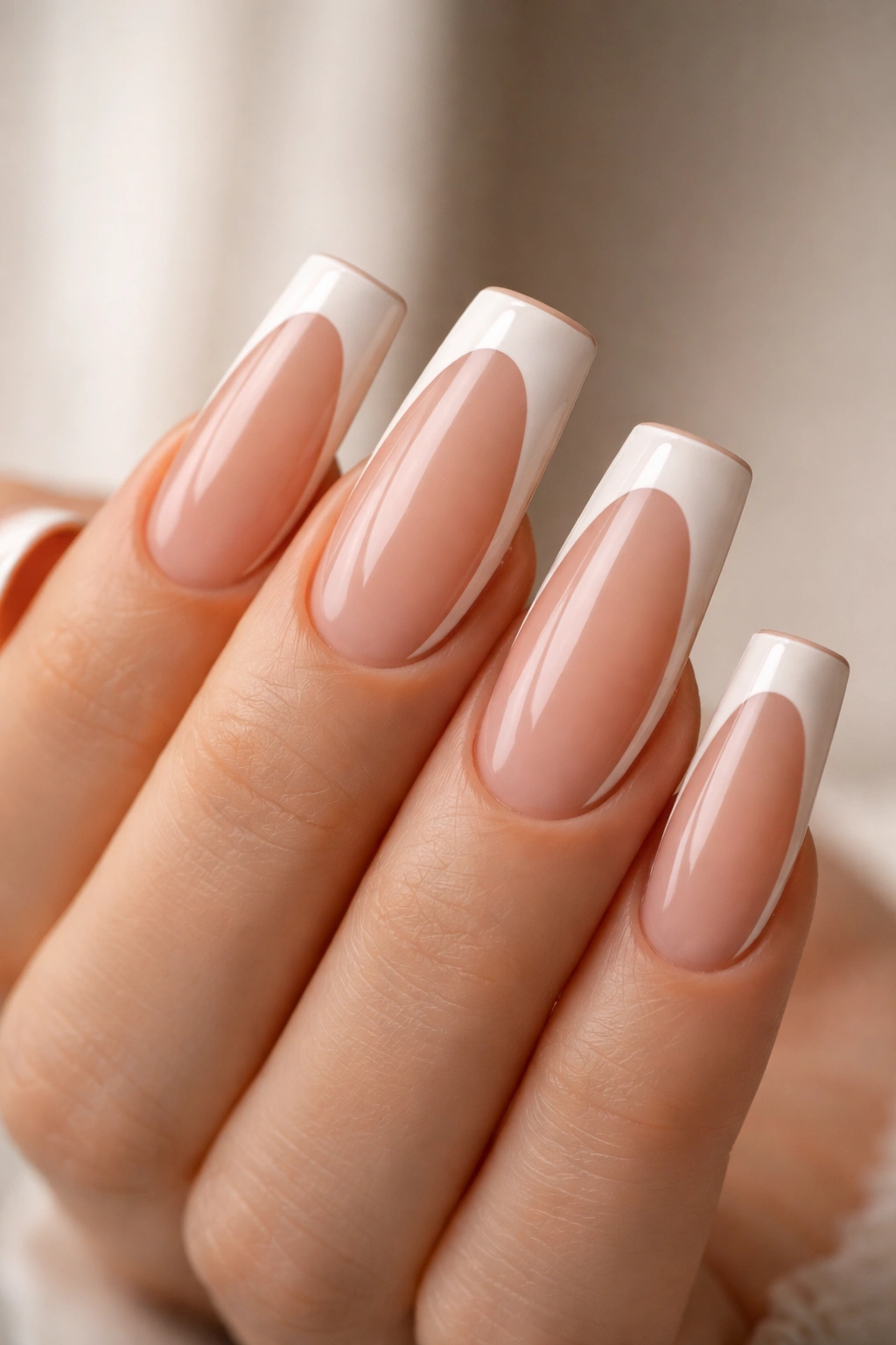 Close-up of duck nails with white tips and nude edge along sides