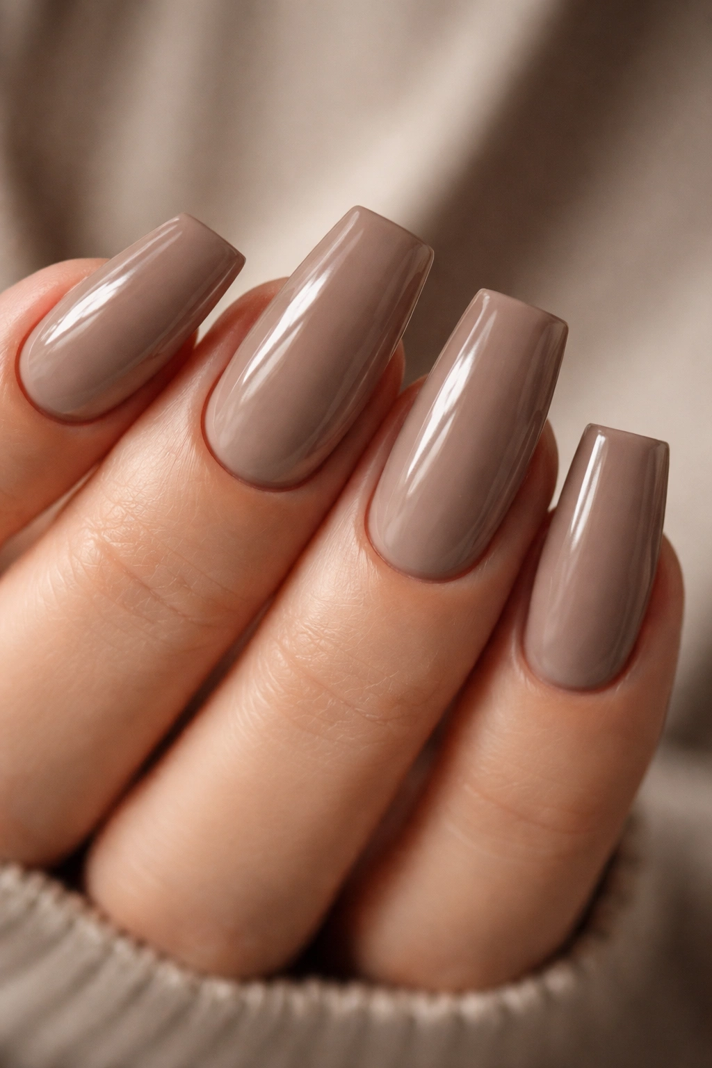 Close-up of duck nails in warm taupe with depth