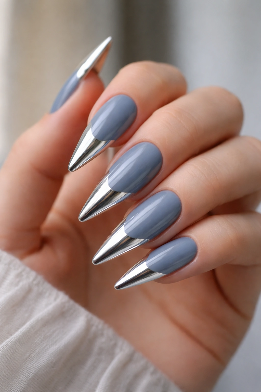 Dusty blue nails with silver mirror powder tips on stiletto nails