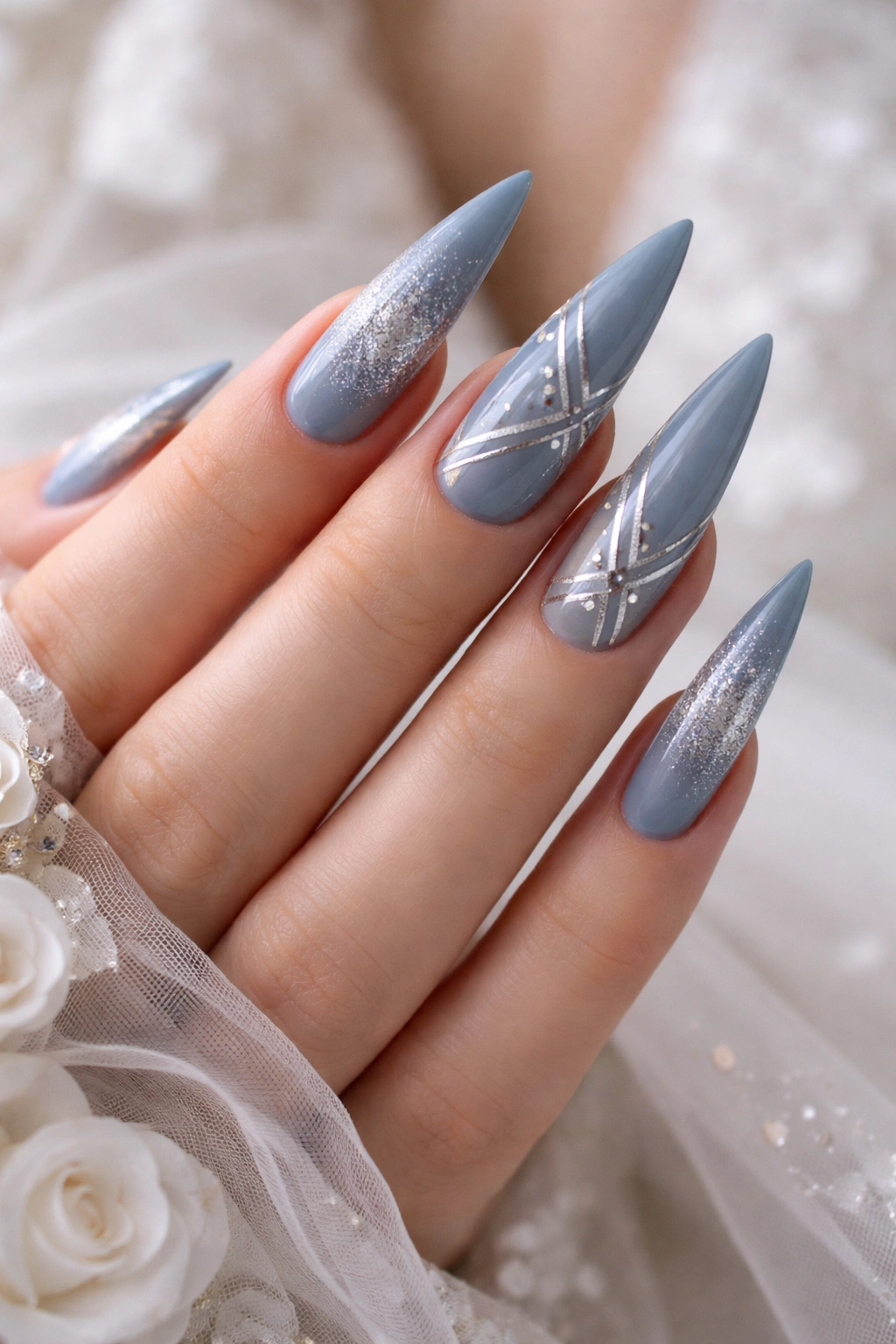 Dusty blue stiletto nails with silver lines and geometric details