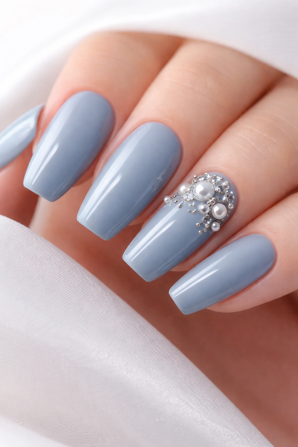 Dusty blue nails with pearl and crystal accents on accent nails