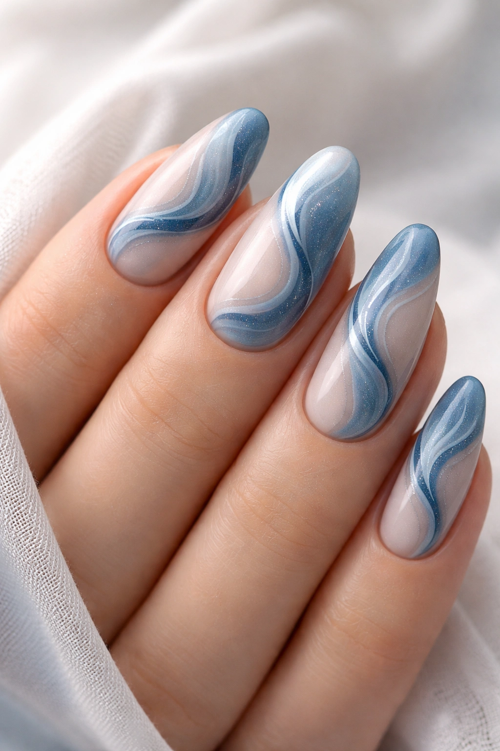Dusty blue nails with swirls and abstract art in close-up
