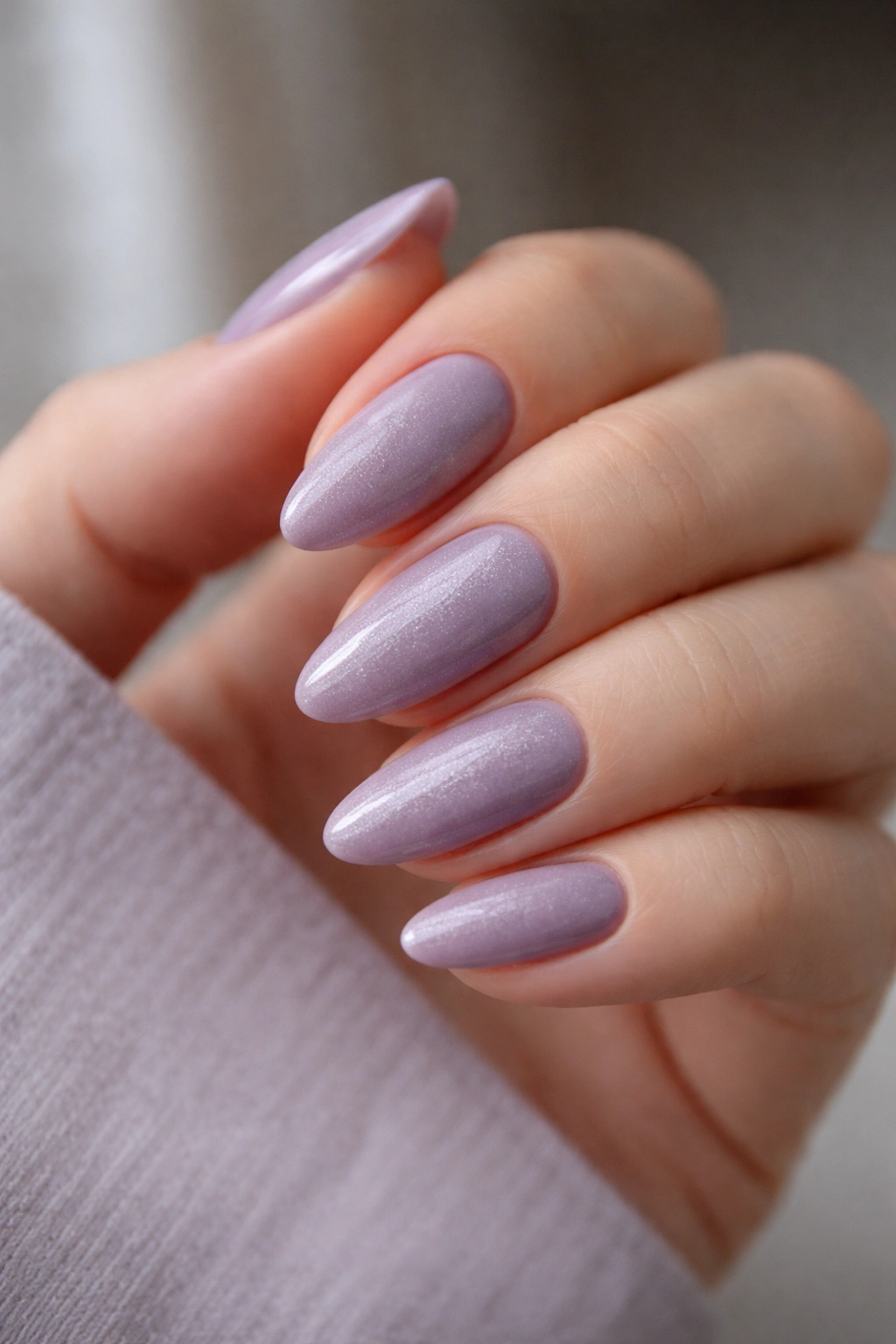 Close-up of dusty lavender almond nails with cool undertone and subtle shimmer