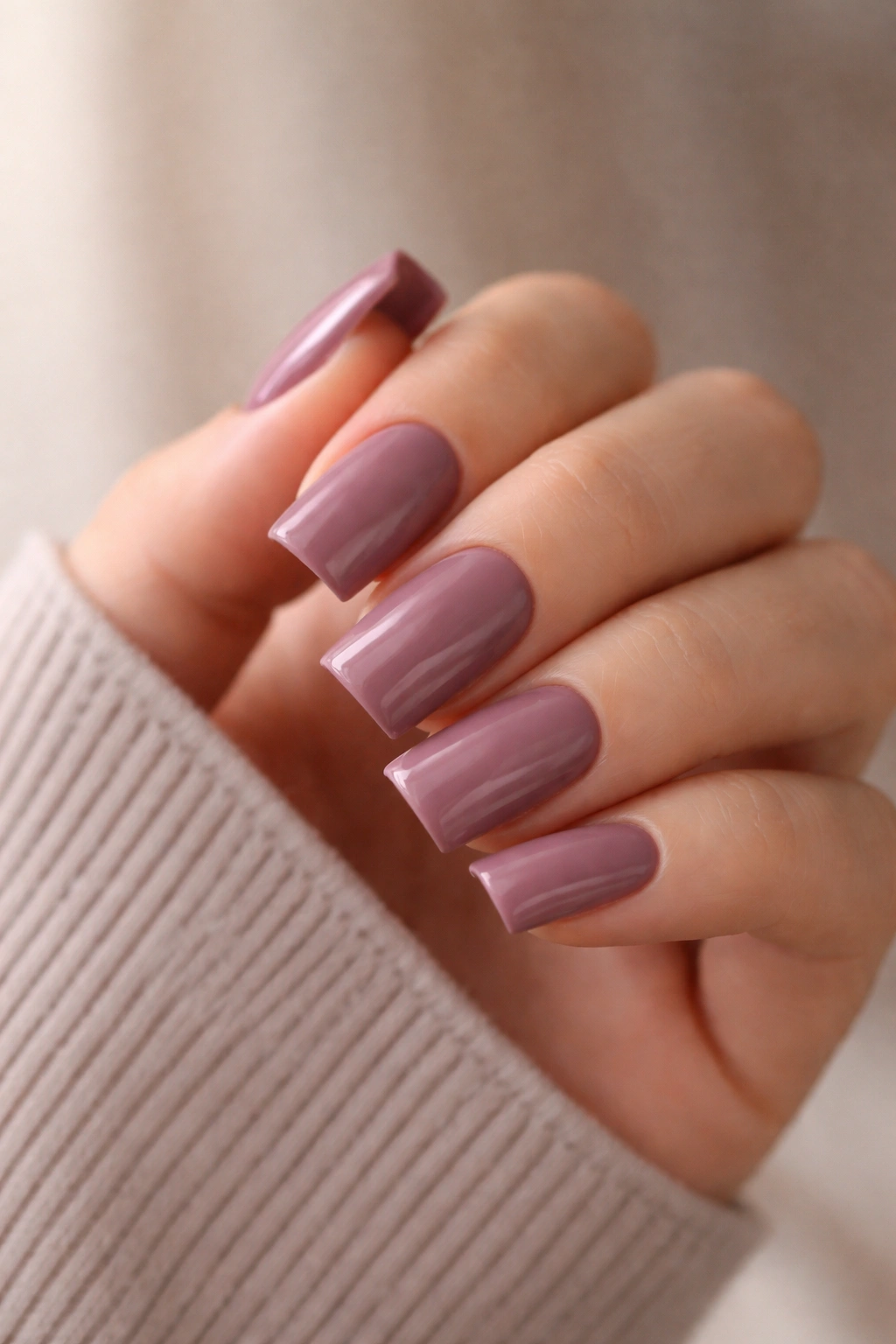 Close-up of short duck nails in dusty mauve shade