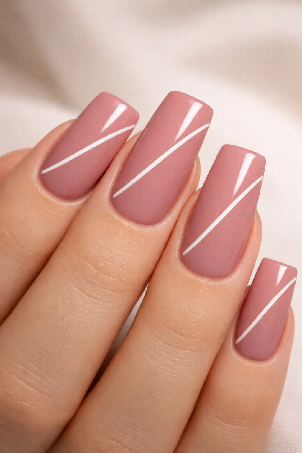 Close-up of dusty rose duck nails with a white minimalist element