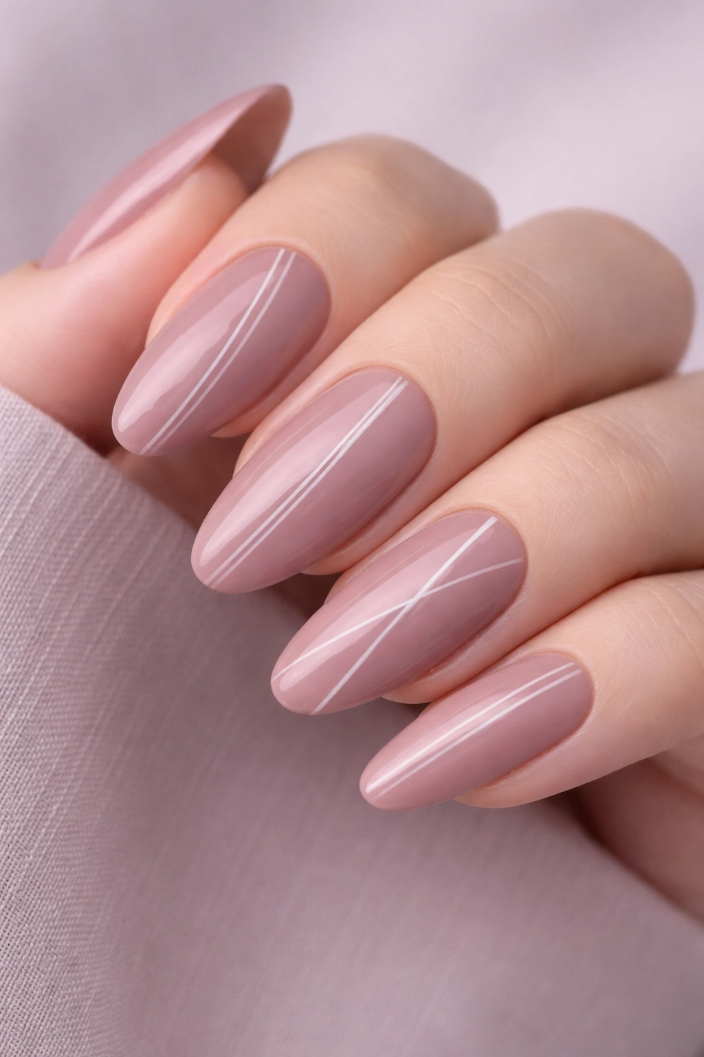 Dusty mauve pink nails with thin line art.
