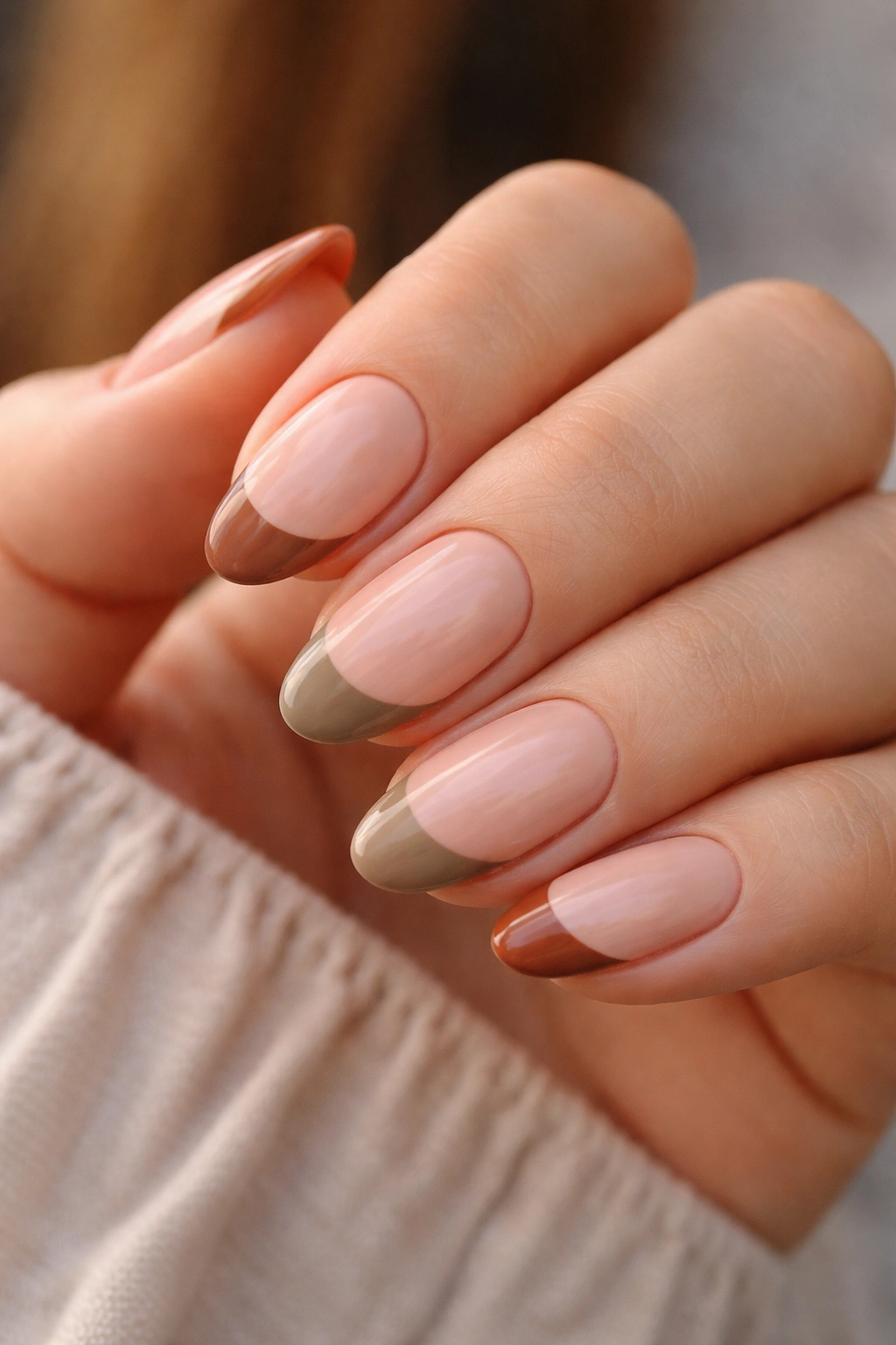 Earth-tone French tips on short almond nails