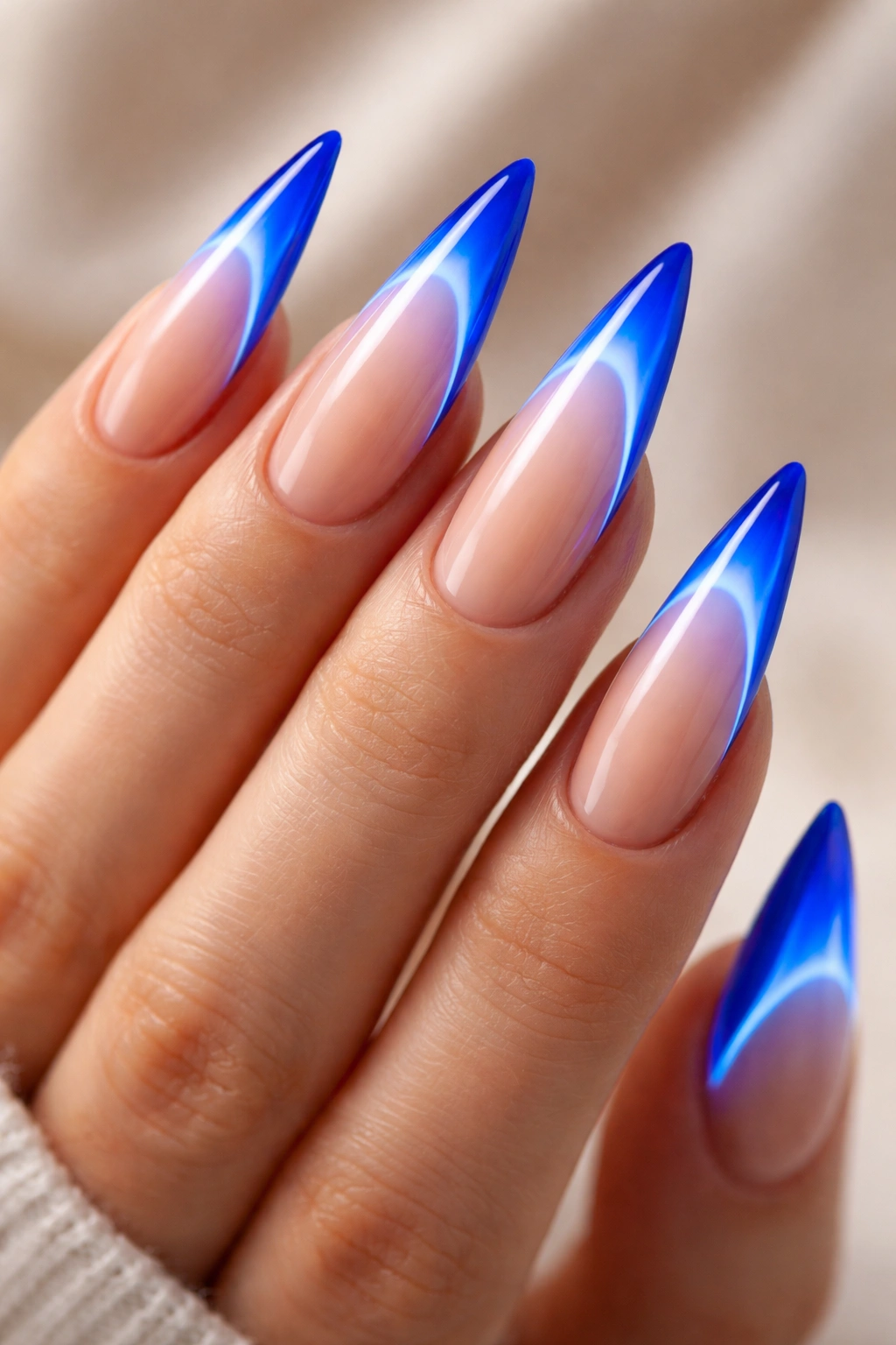 Electric neon blue French tip nails on a stiletto nail