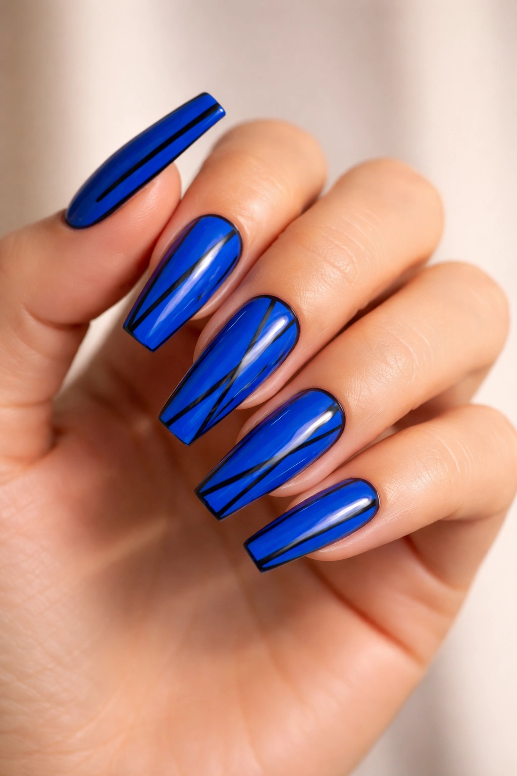 Electric cobalt nails with black line details close-up