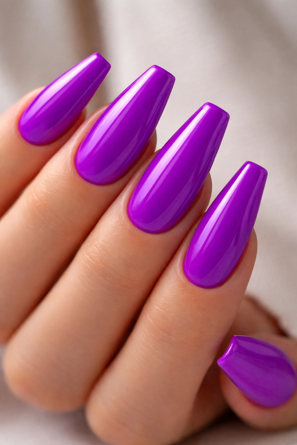 Electric purple neon coffin nails close-up