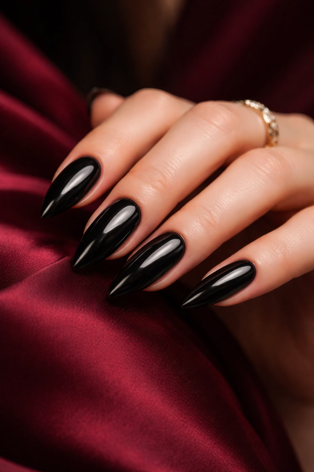 Close-up of elegant black nails on a hand with a muted background