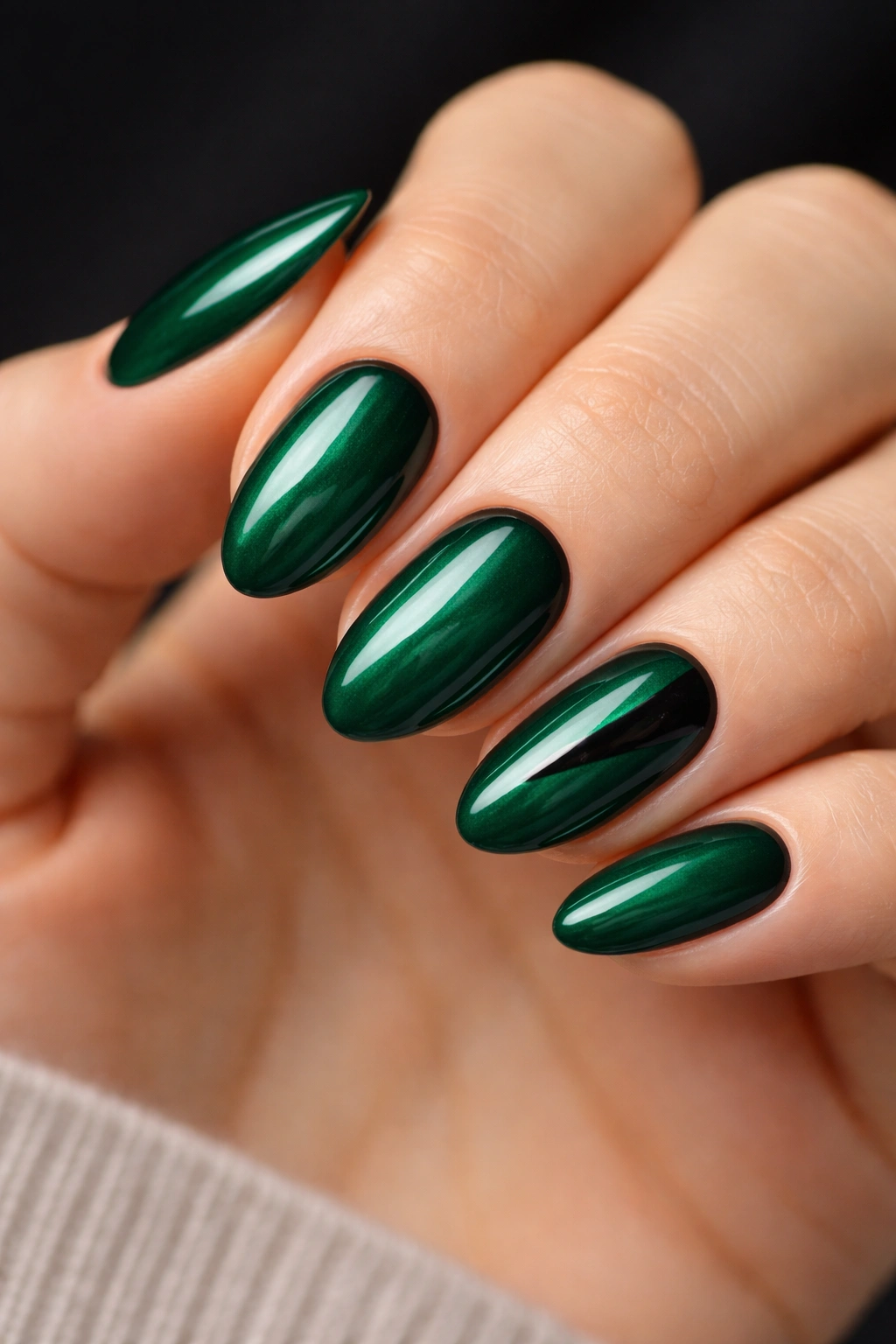 Short almond nails with emerald base and black accents