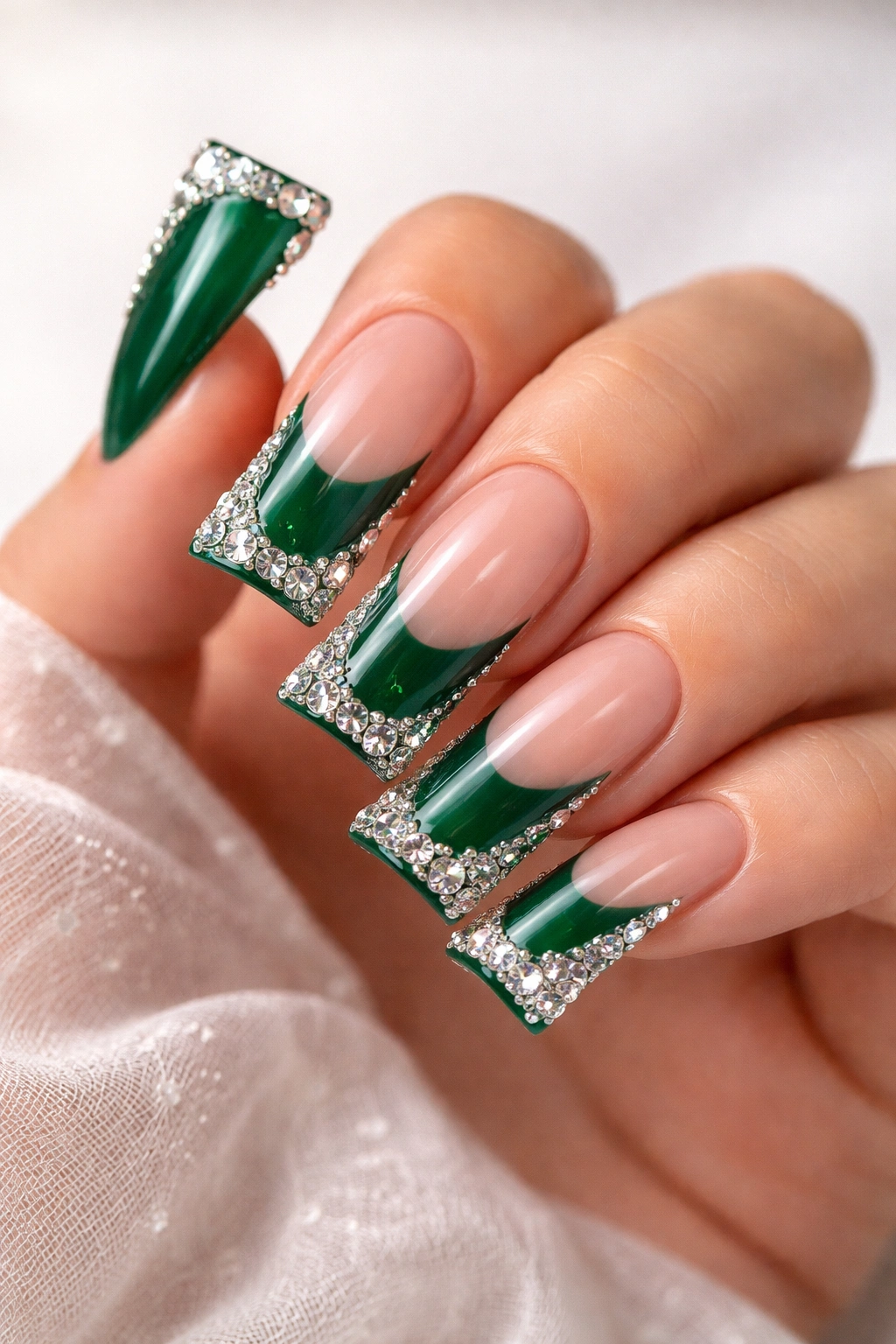 Close-up of emerald green duck nails with diamond accents on tips