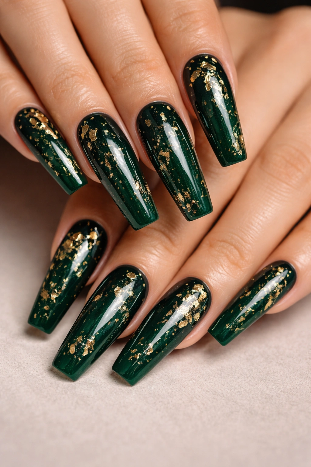 Emerald green coffin nails with floating gold foil flakes under clear top coat