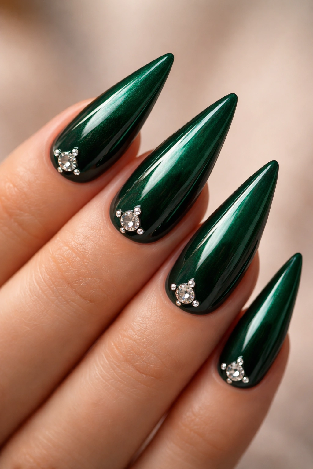 Emerald green nails with diamond accents on a neutral background