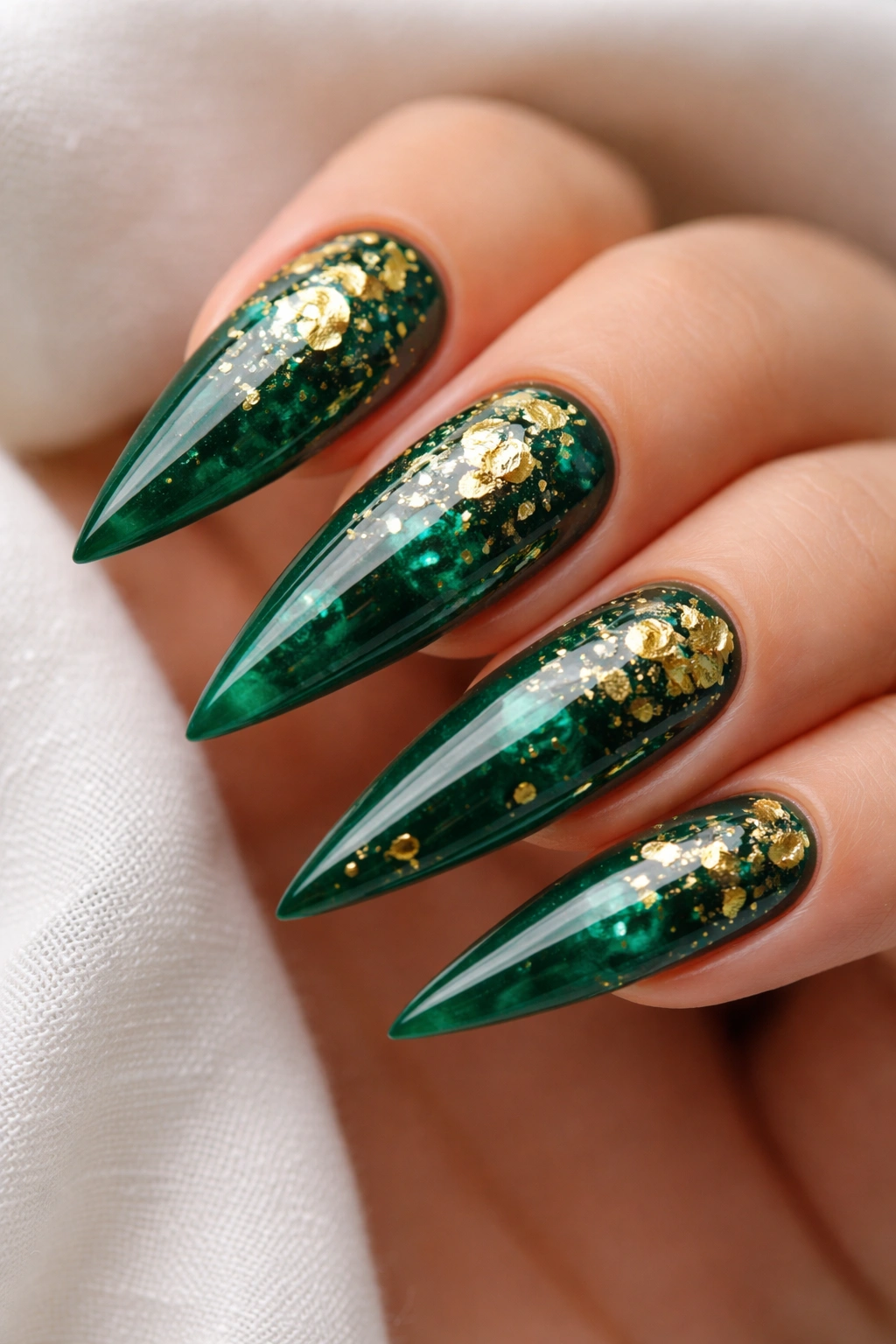 Emerald green nails with gold leaf accents and glossy finish