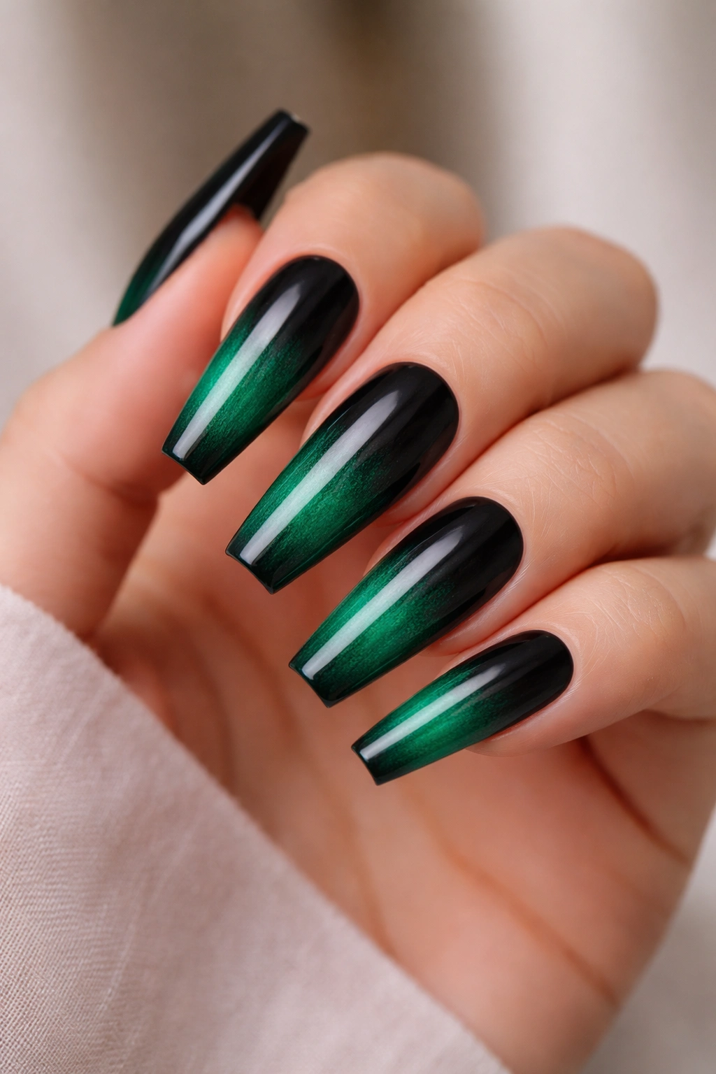 Coffin nails with black to emerald ombre on a hand