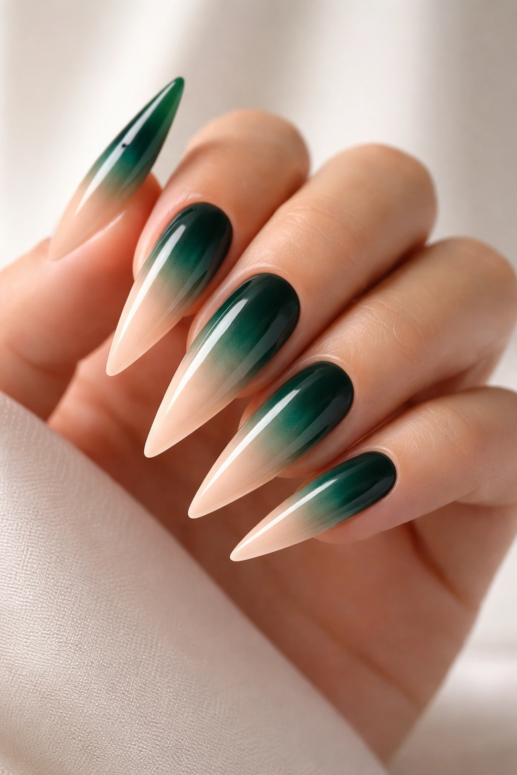 Emerald to nude ombre stiletto nails with smooth gradient