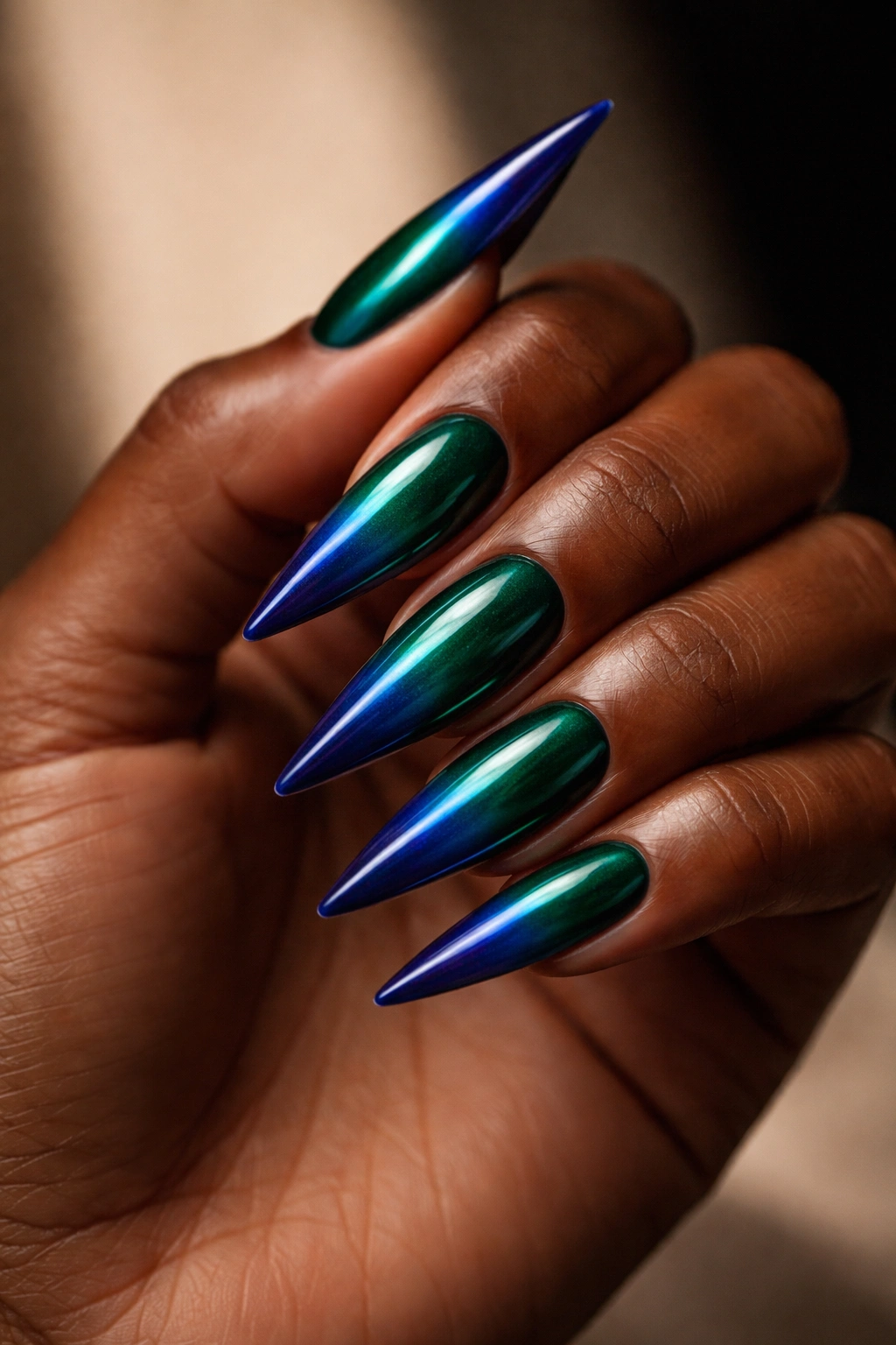 Emerald to sapphire ombre stiletto nails.