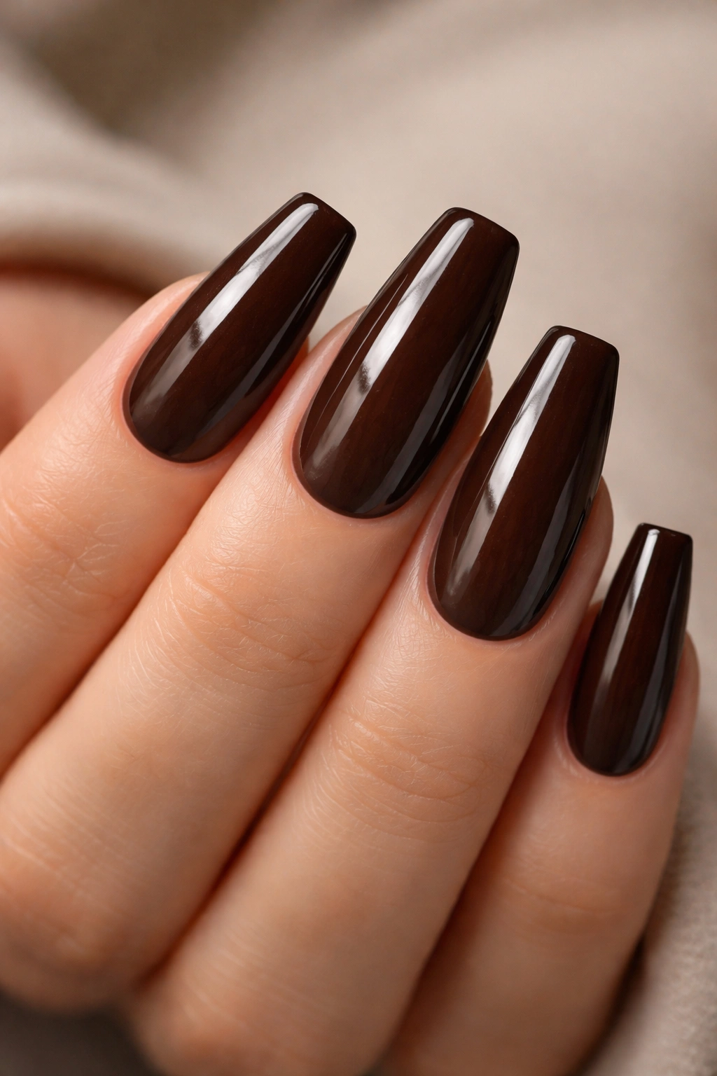 Espresso brown coffin nails with glossy finish showing depth