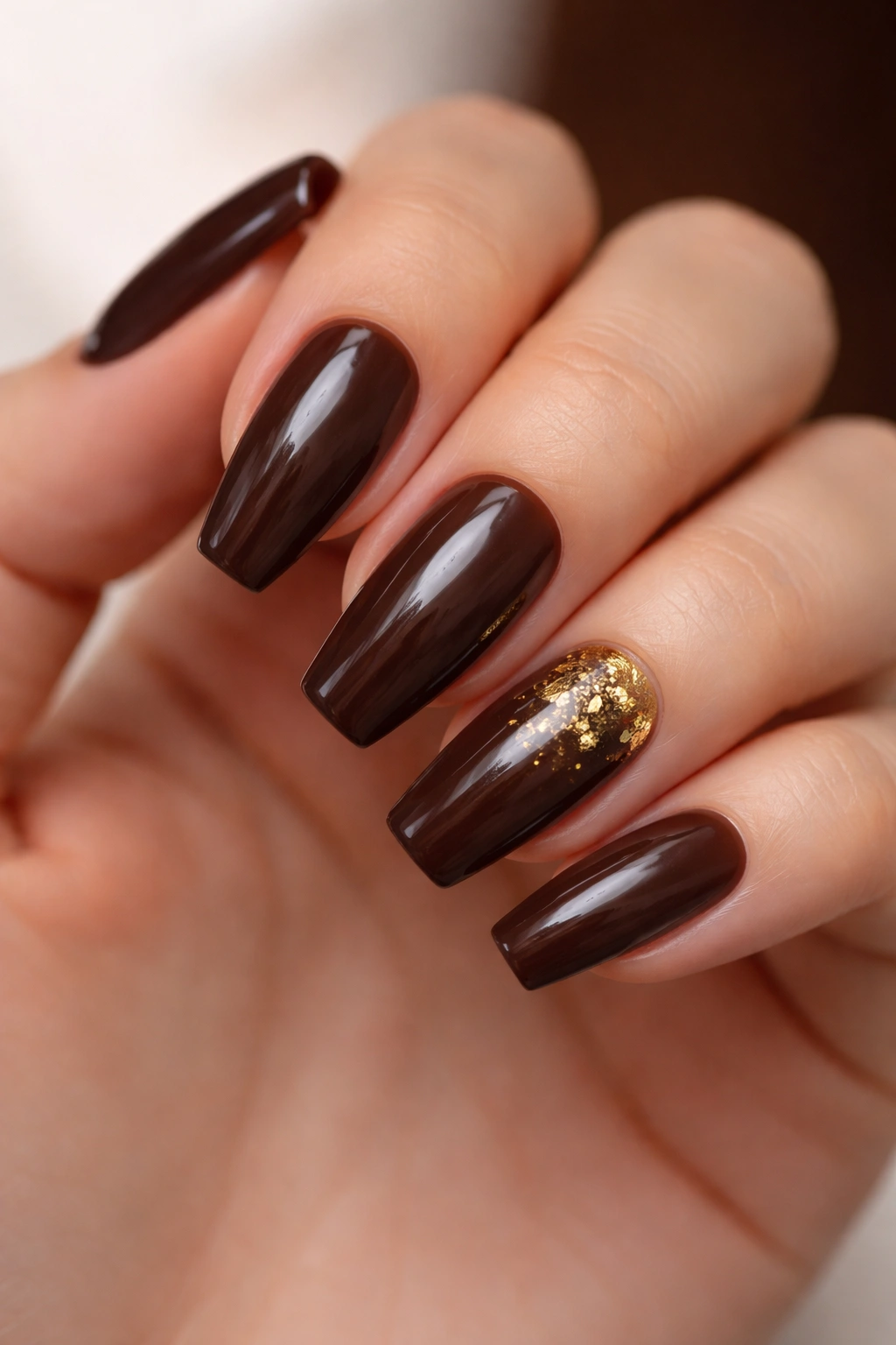 Espresso brown ballerina nails with subtle gold foil accents