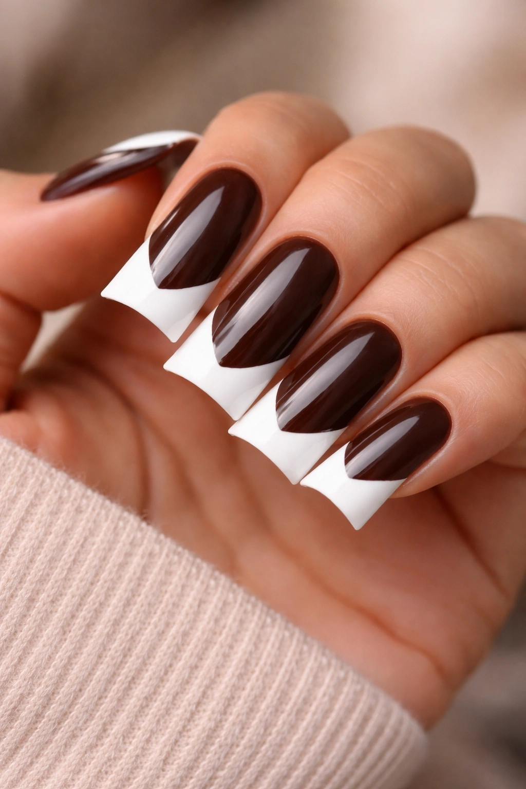 Close-up of espresso brown nails with white contrast tips