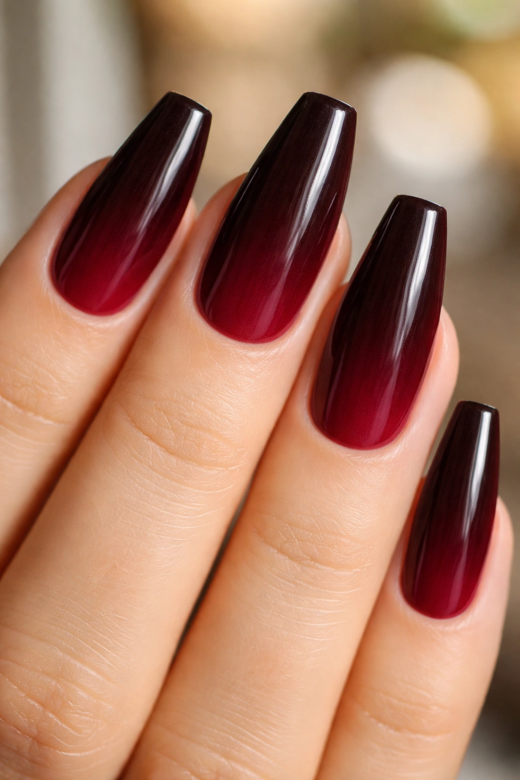 Espresso to burgundy ombré on a ballerina nail with vertical gradient