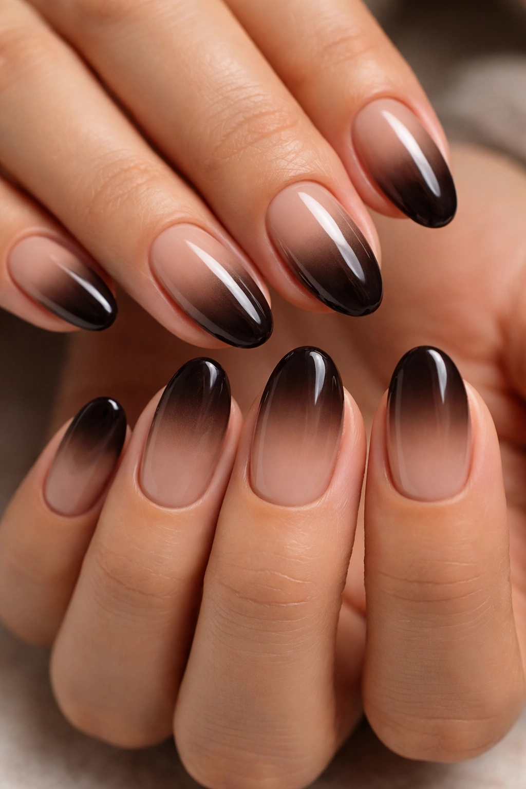 Close-up of short almond nails with espresso ombre gradient