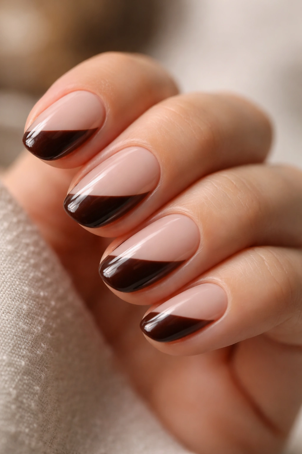 Close-up of side-French espresso tip on short oval nails