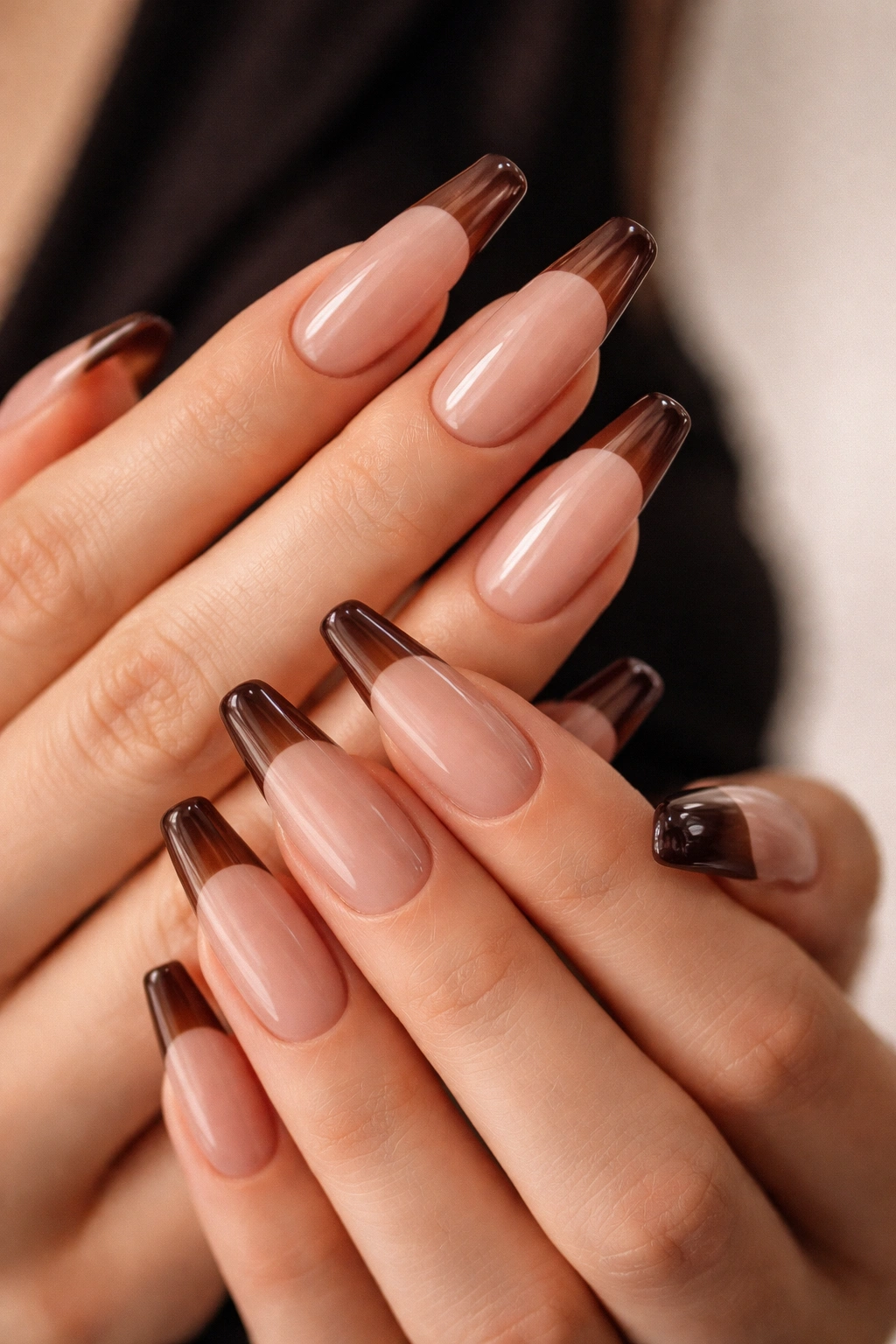 Espresso-tinted sheer tips on nude ballerina nails