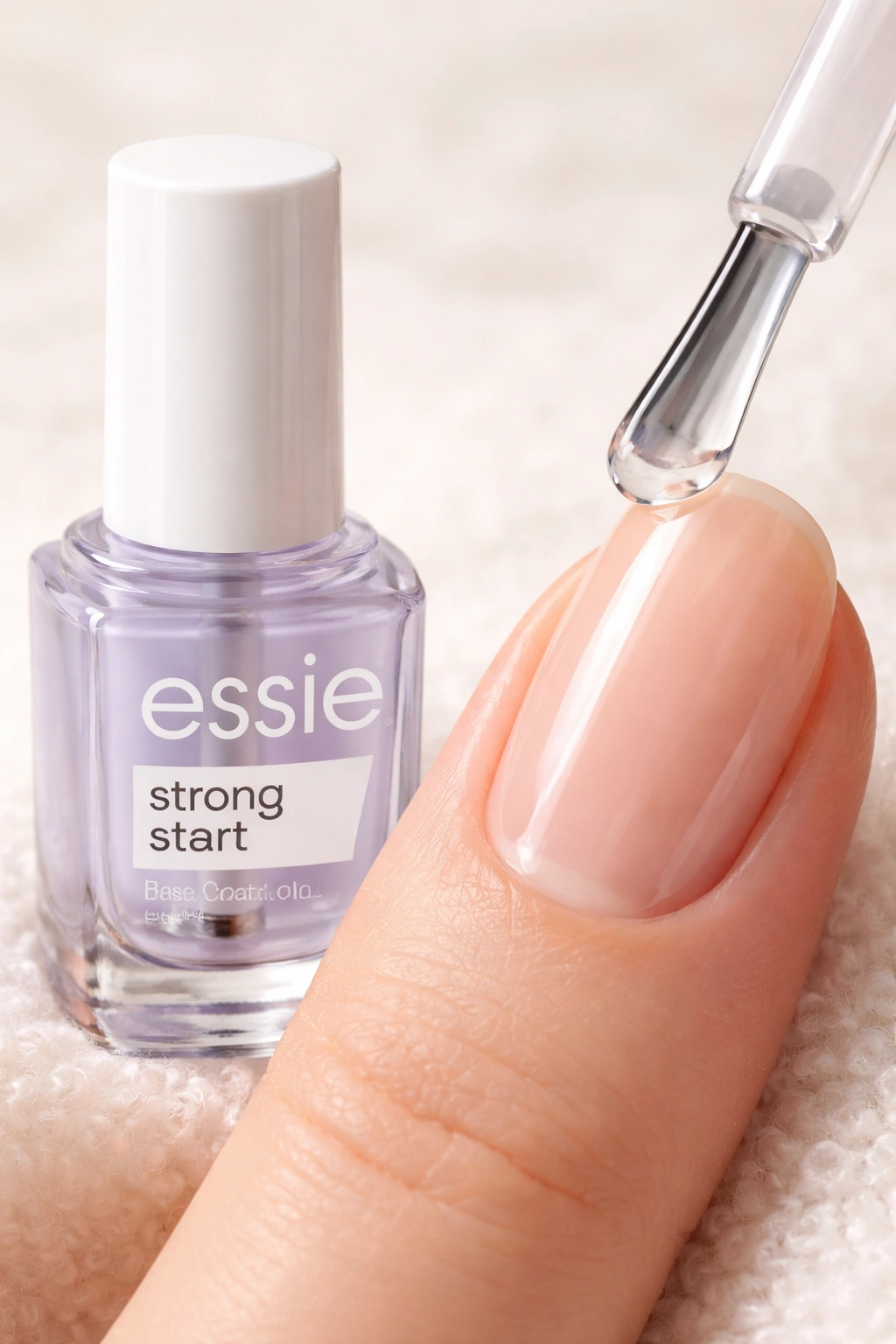 Unmarked bottle silhouette beside smooth manicured nail