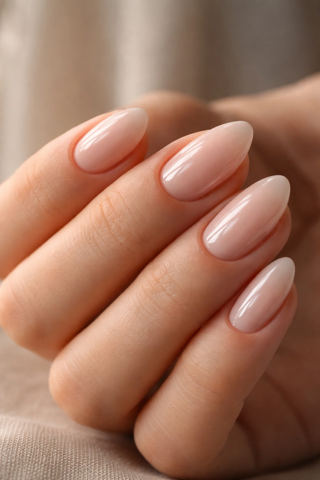 Close-up of short almond nails with glossy finish and clean cuticle lines