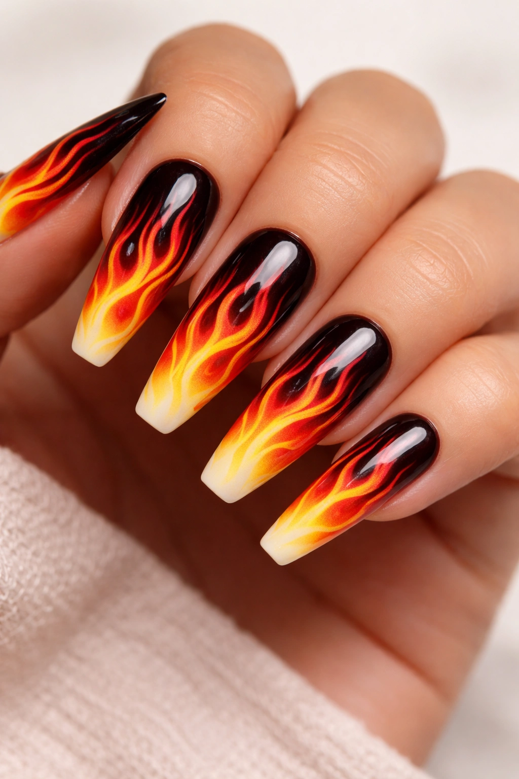 Nails with flame nail art showing fiery gradient colors