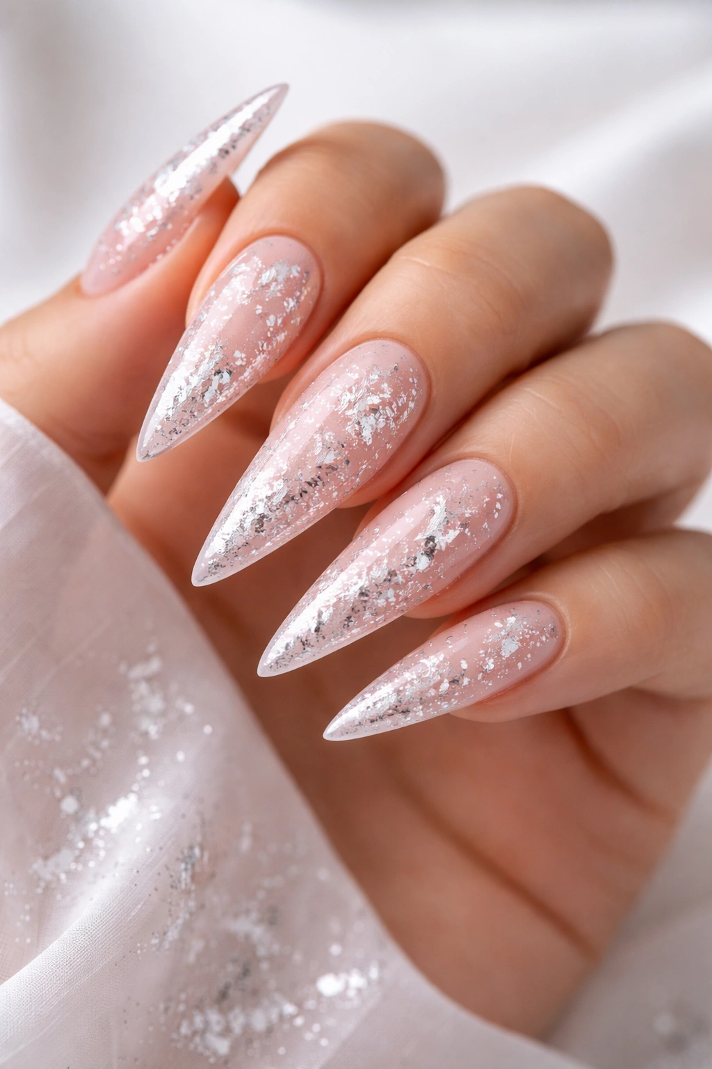 Champagne pink stiletto nails with silver foil flakes