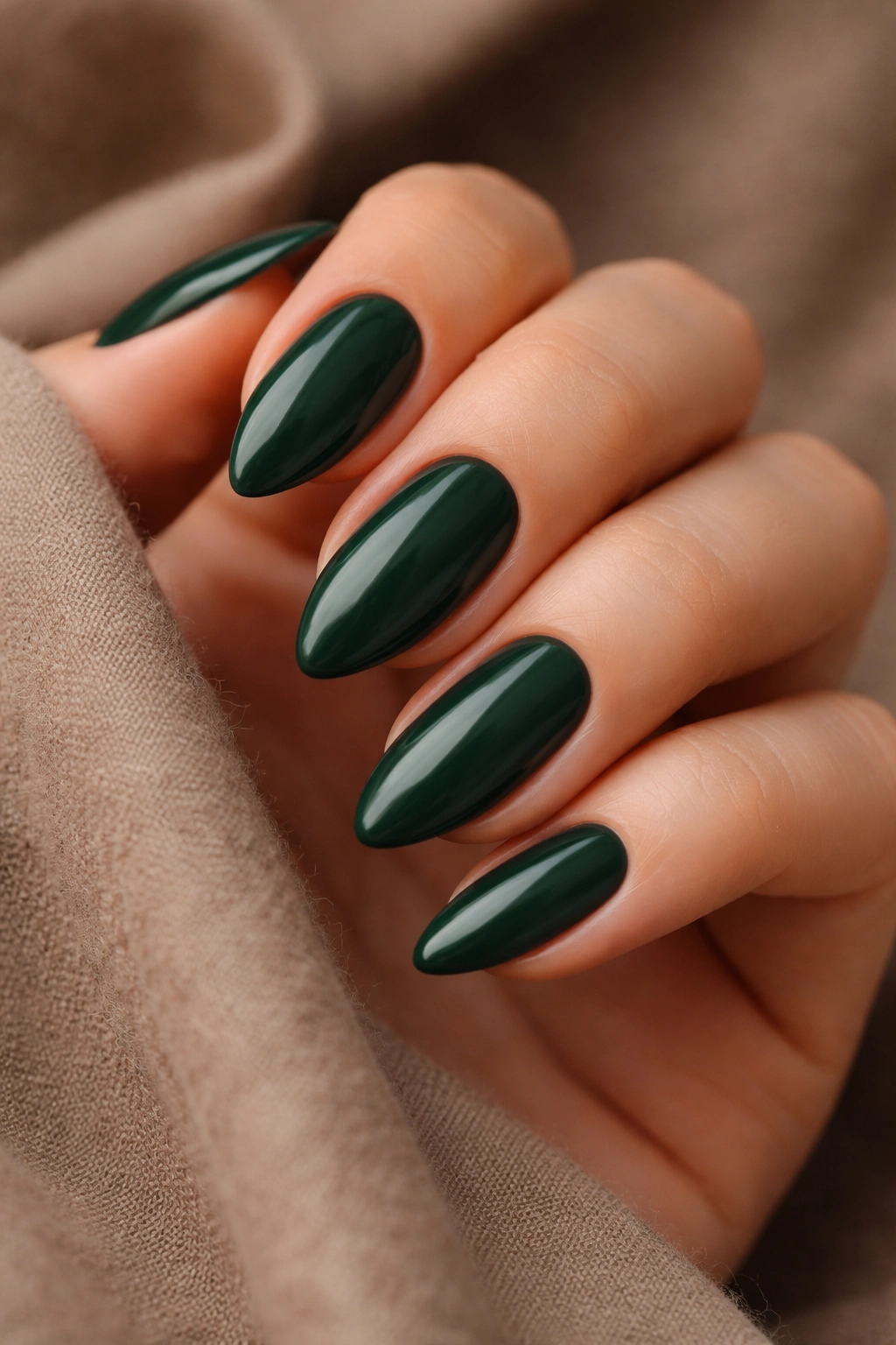 Almond nails forest green creme color on bare hand