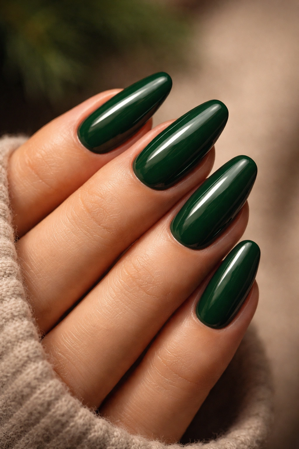 Close-up of hand with forest green glossy nails